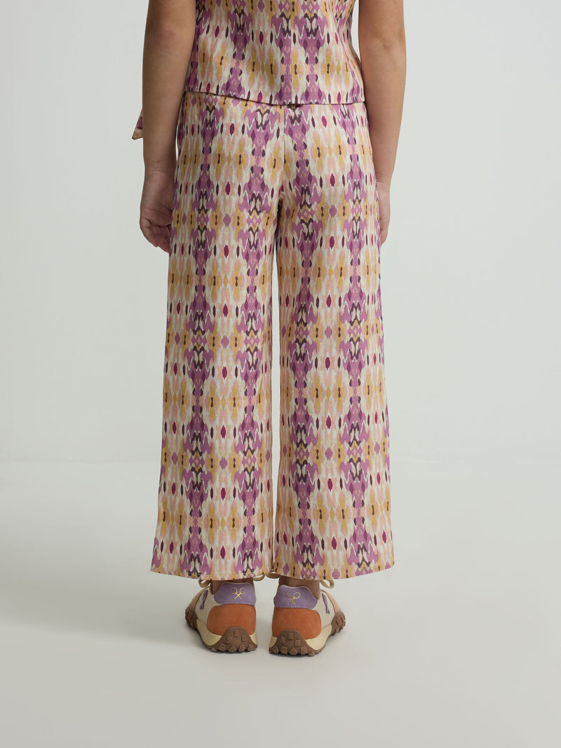 Calças de menina em linho estampado ikat rosas