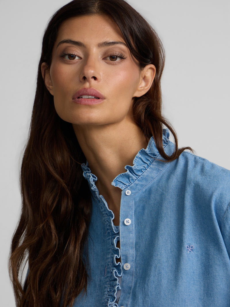Denim shirt with ruffle collar and cuff detail
