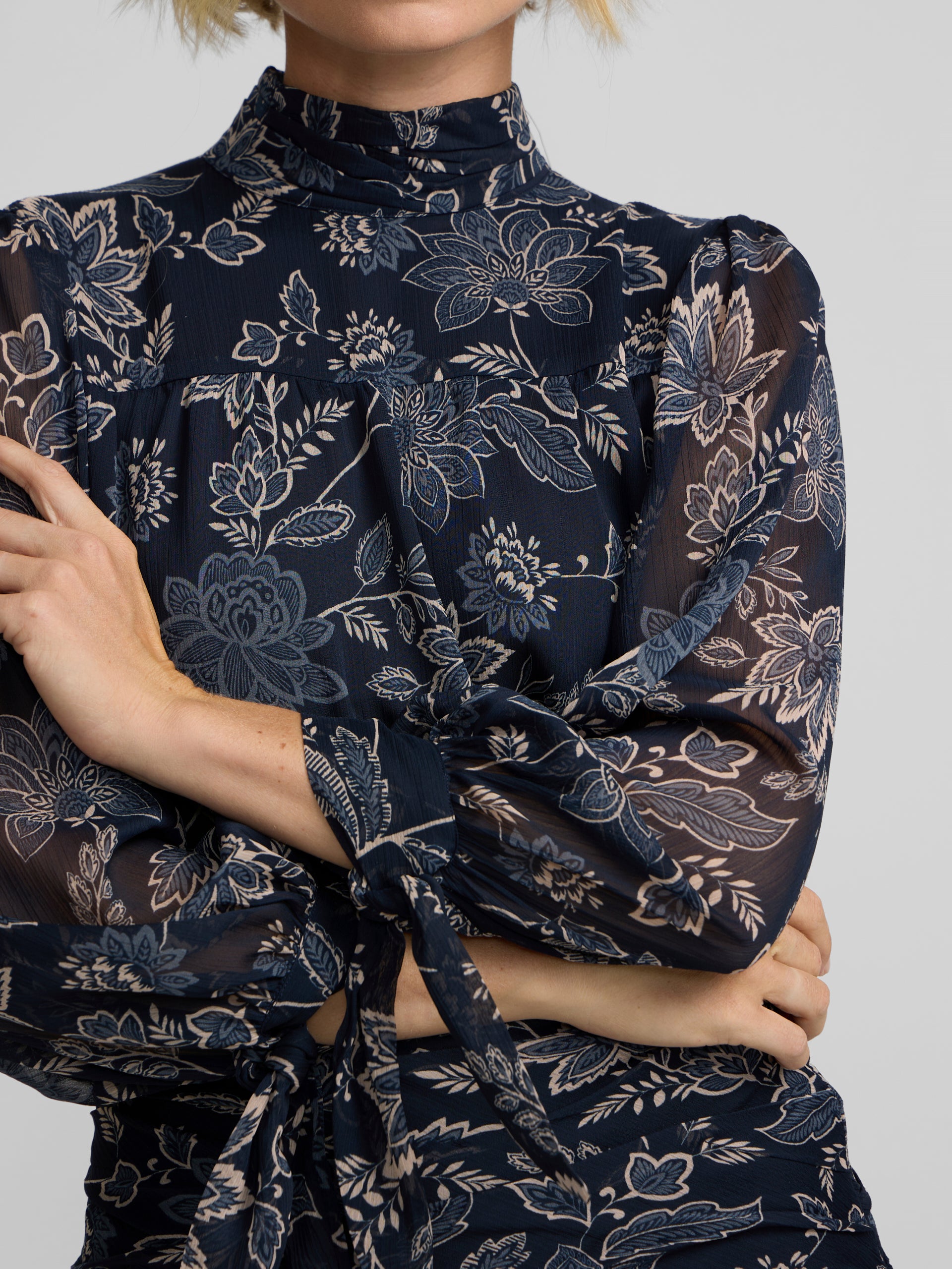Blue floral print blouse with tied sleeves