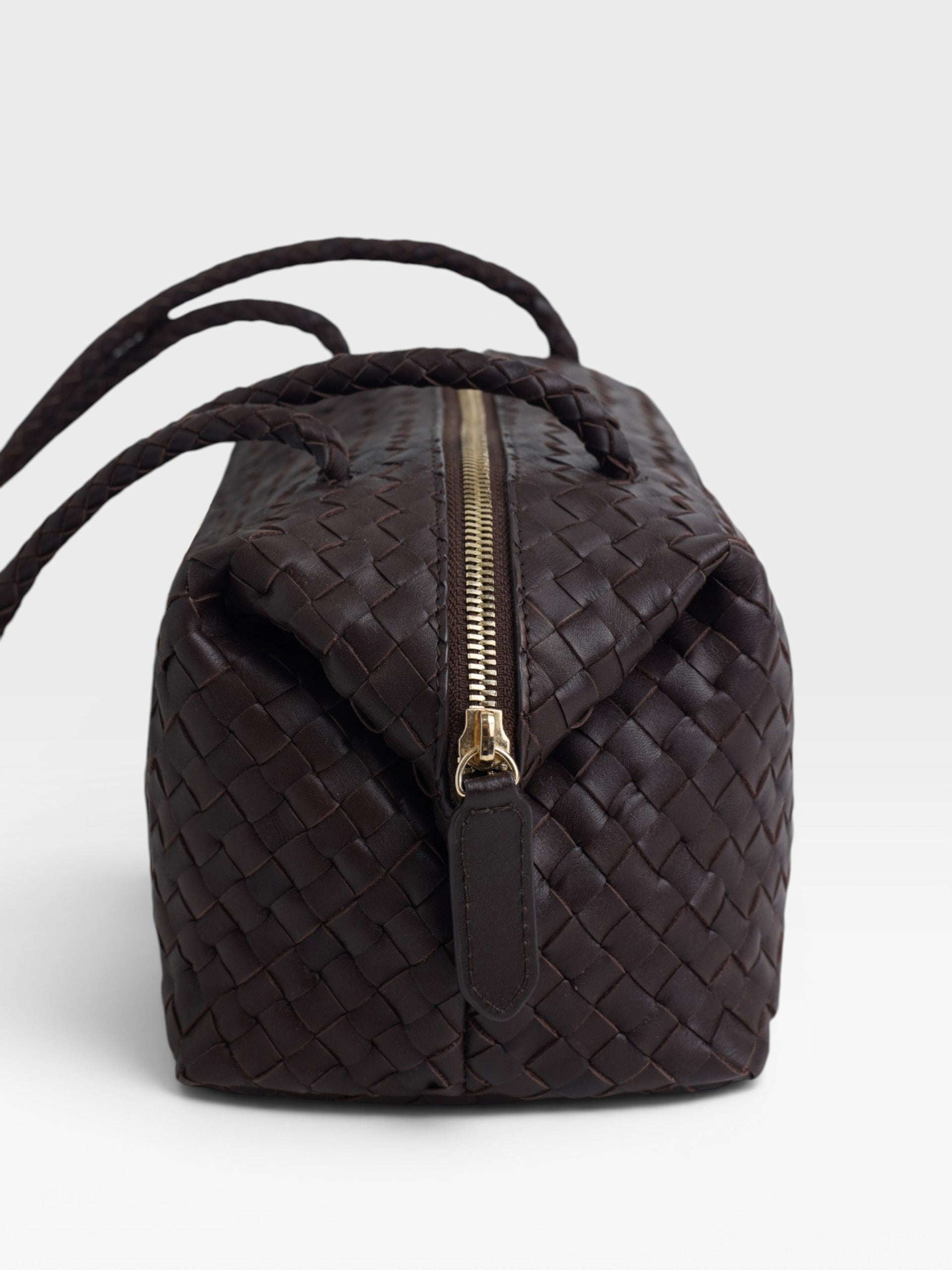 Elongated braided brown leather shoulder bag