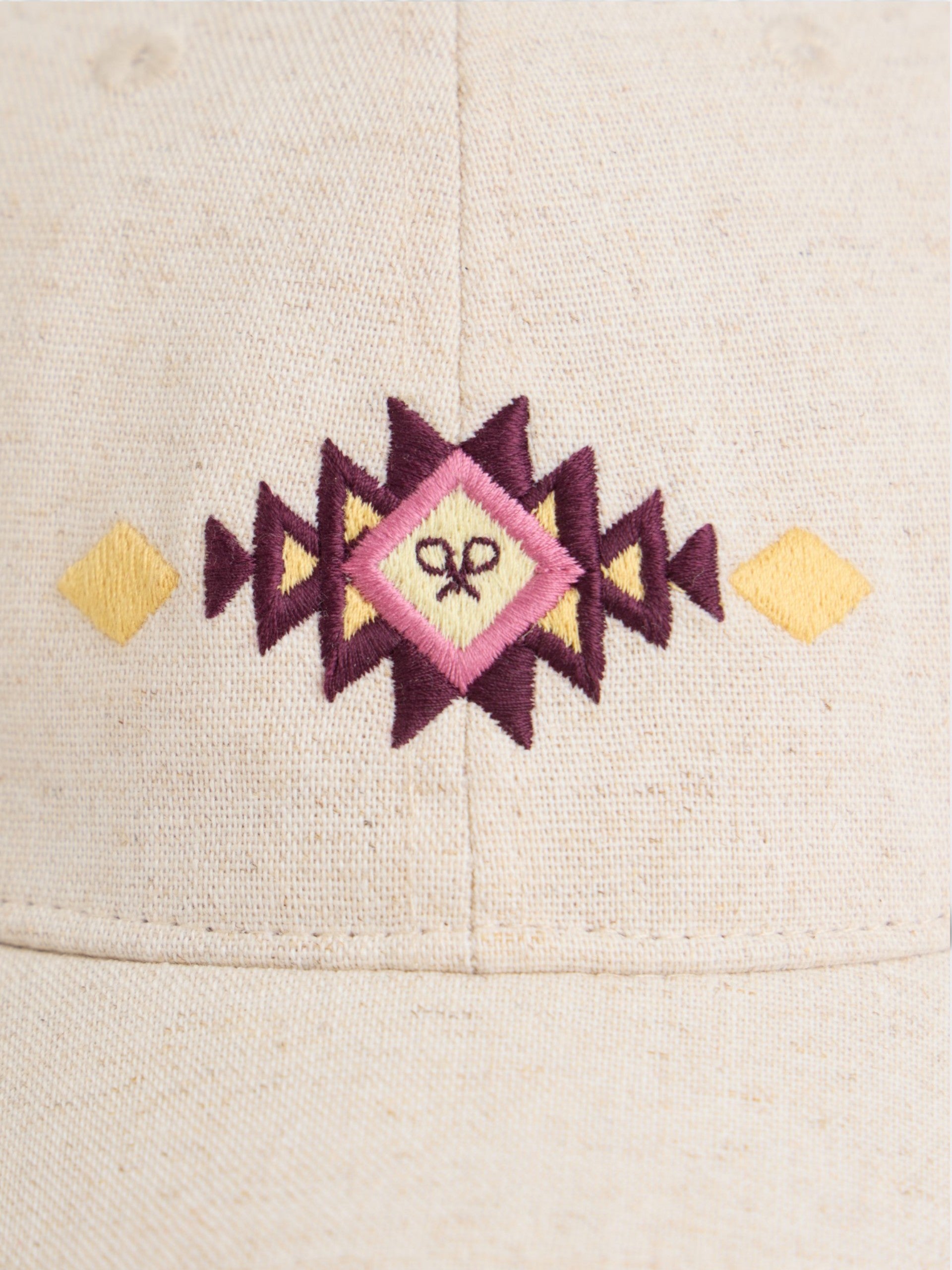 Beige cap with ethnic motif