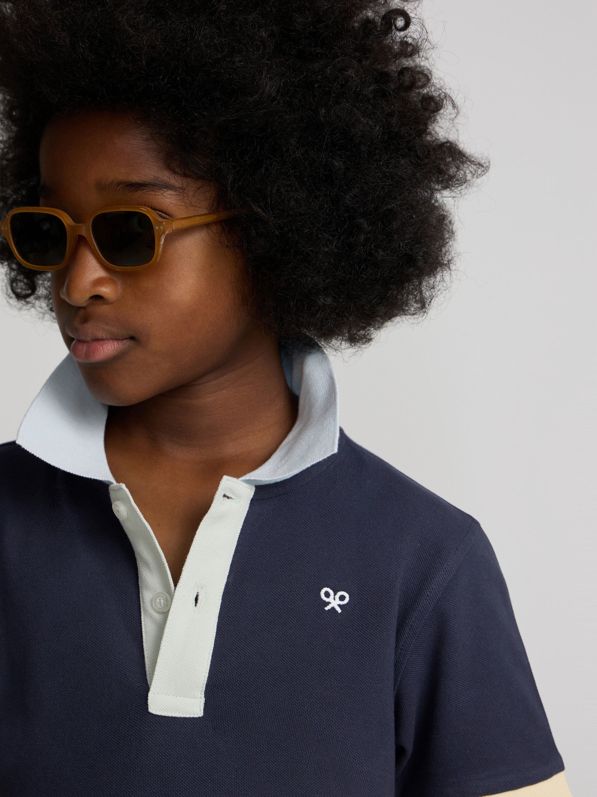 Navy blue kids polo with multicolor trim