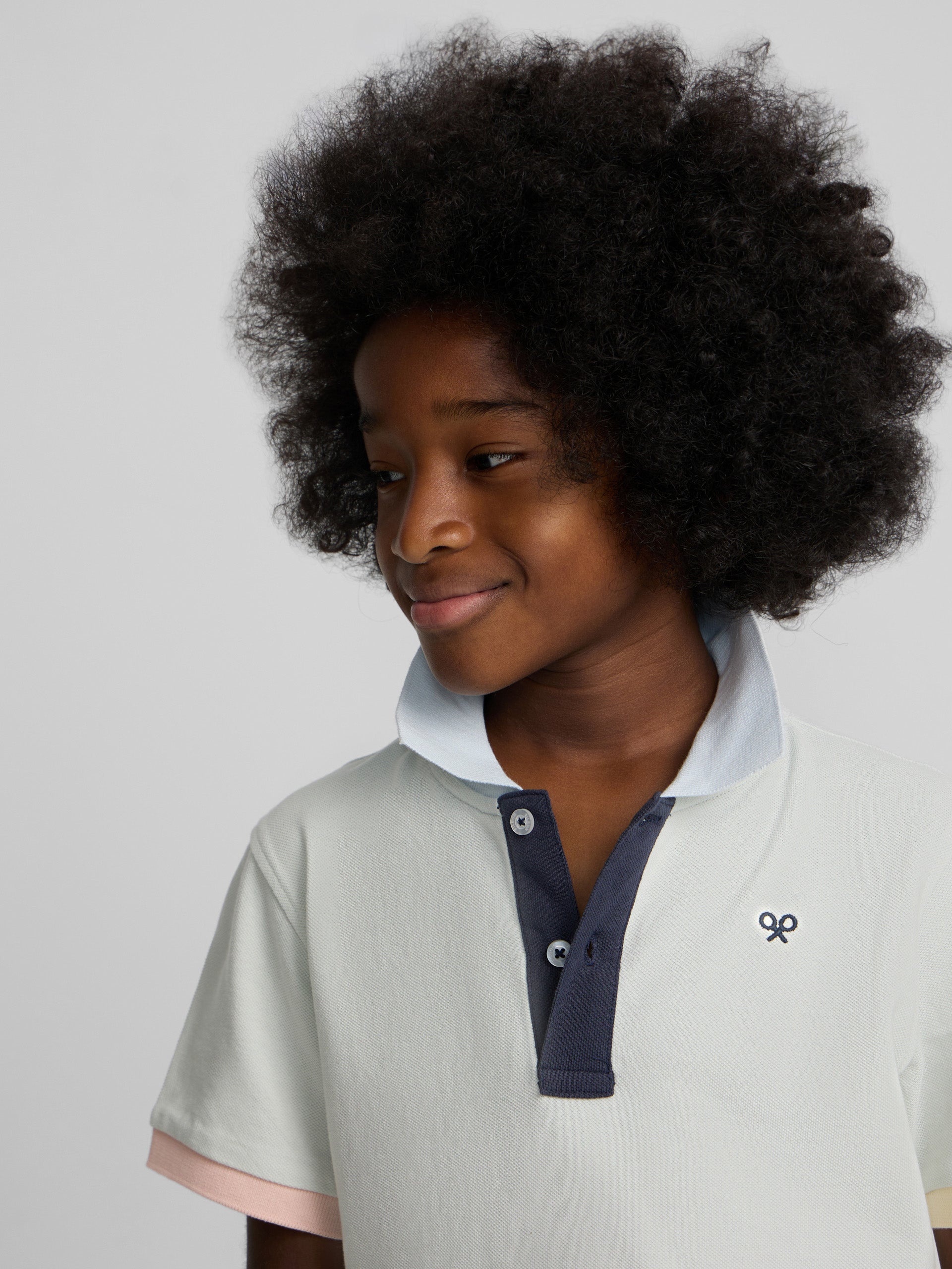 Light green kids' polo with multicolor trim