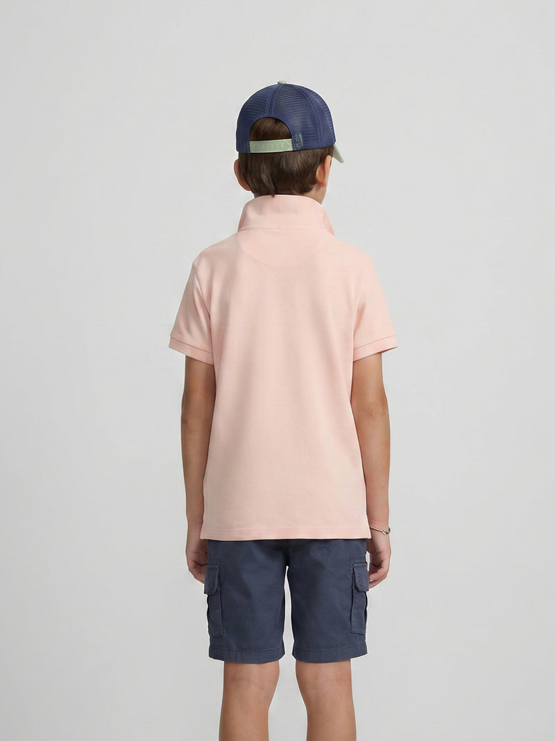 Polo enfant uni logo bouclé corail