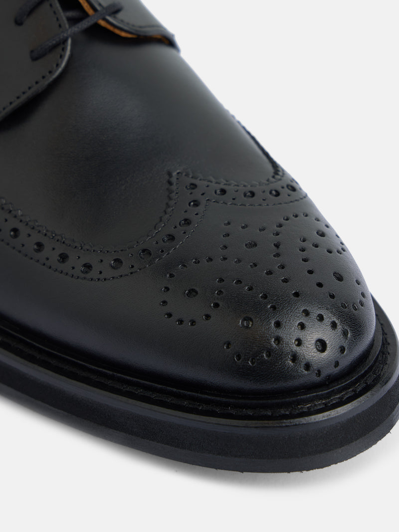 Classic perforated black leather shoe