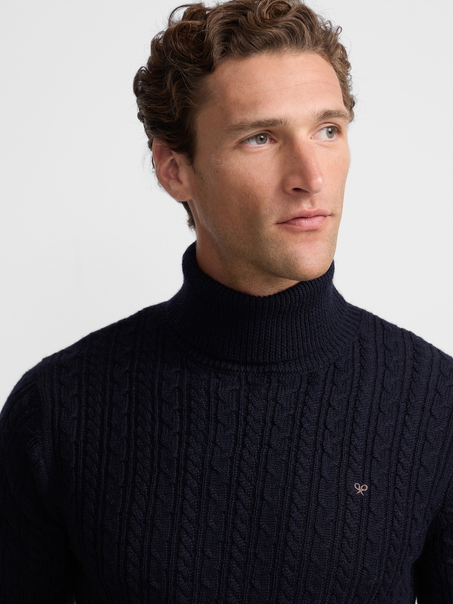 Navy blue cable knit turtleneck sweater