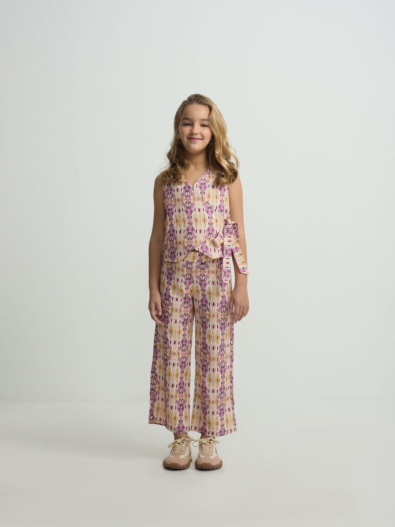Calças de menina em linho estampado ikat rosas