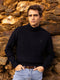 Navy blue cable knit turtleneck sweater