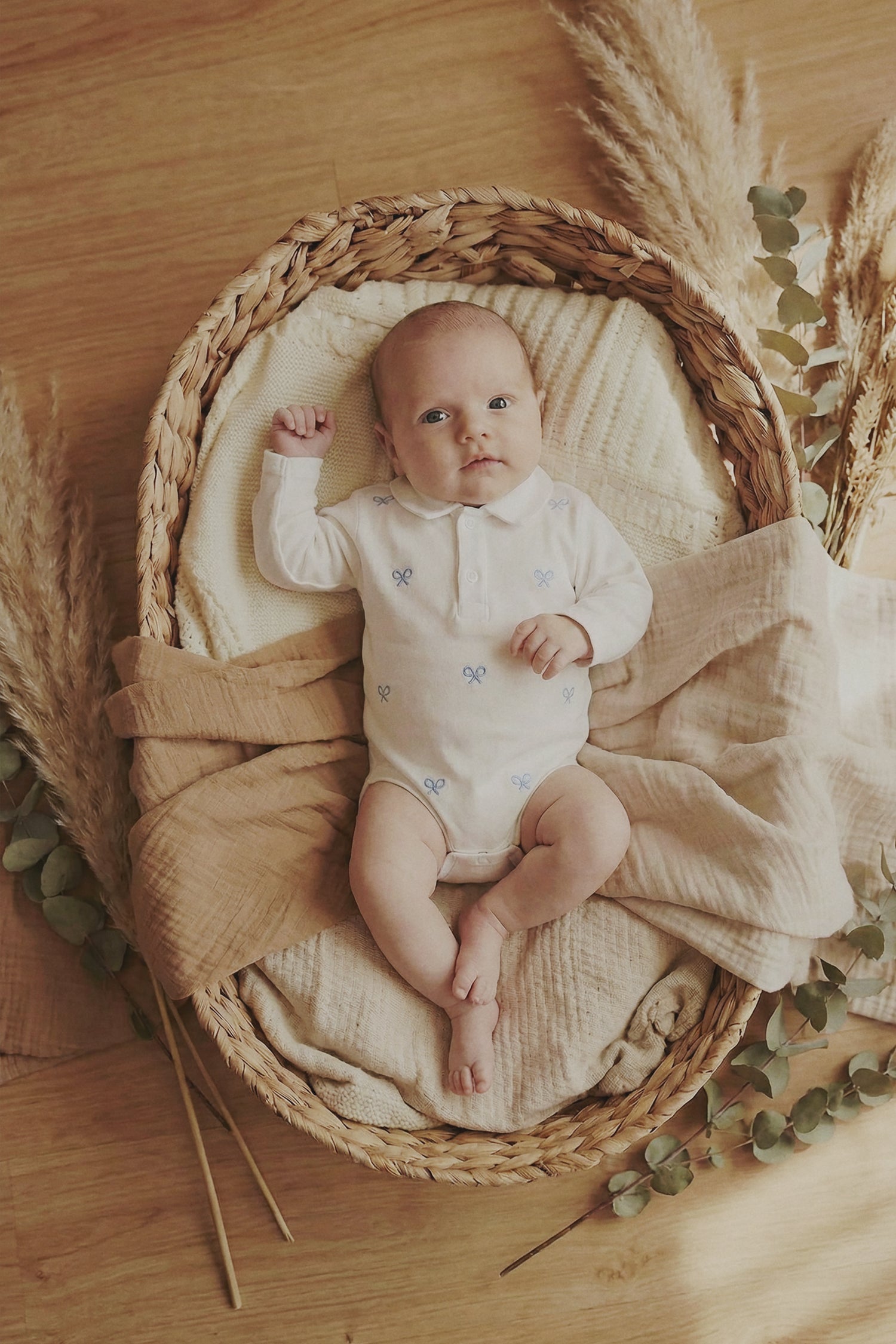 Light blue multi-racket long-sleeved baby bodysuit