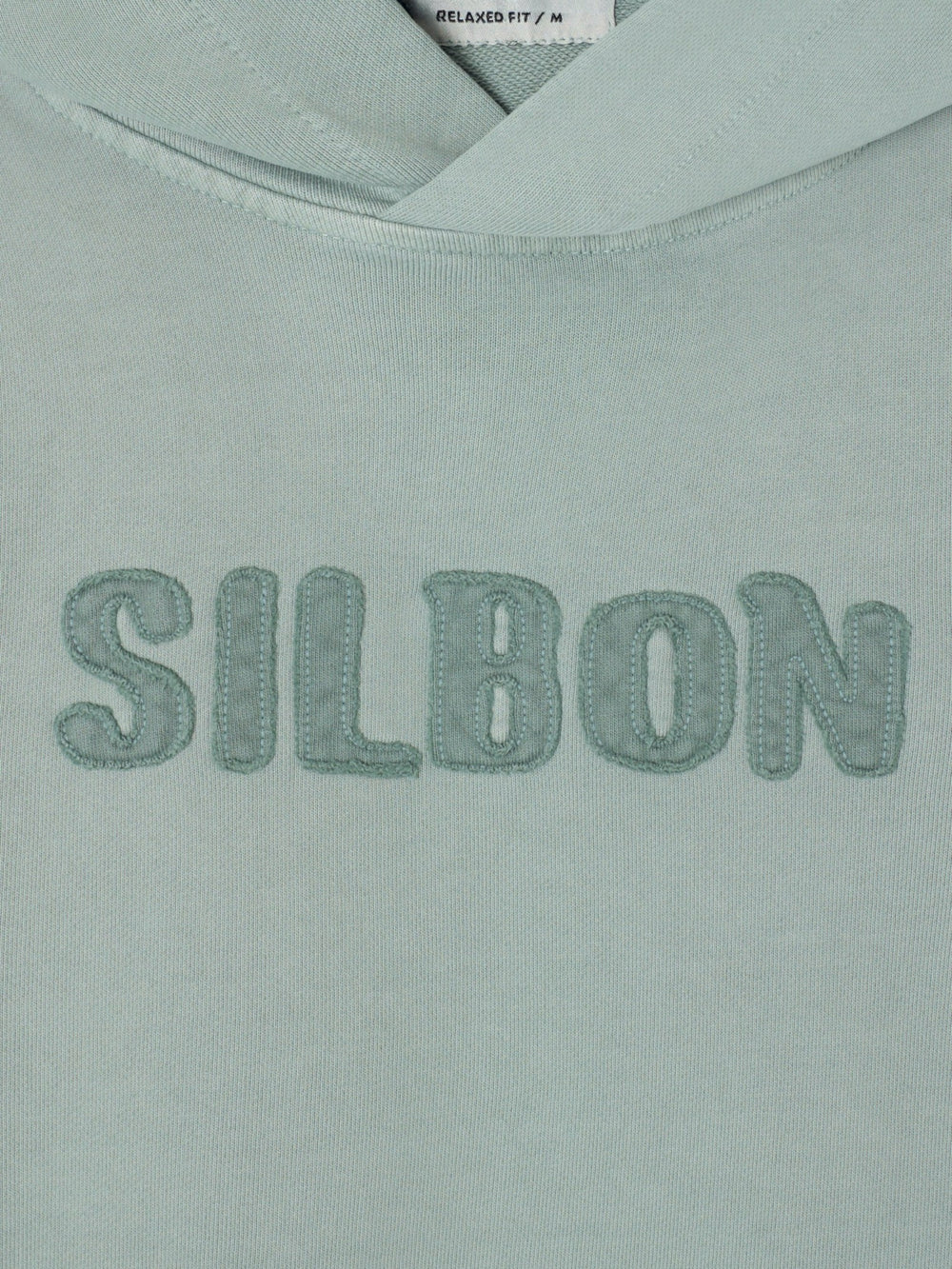 Sudadera capucha parche tono verde claro
