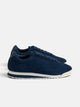 Navy blue suede sneaker with perforated logo