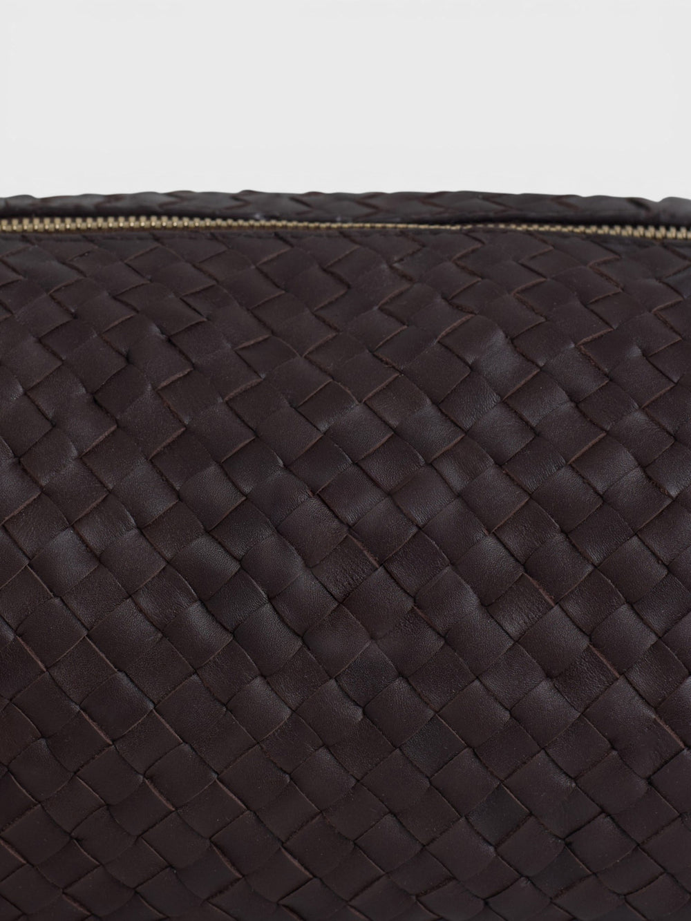 Elongated braided brown leather shoulder bag