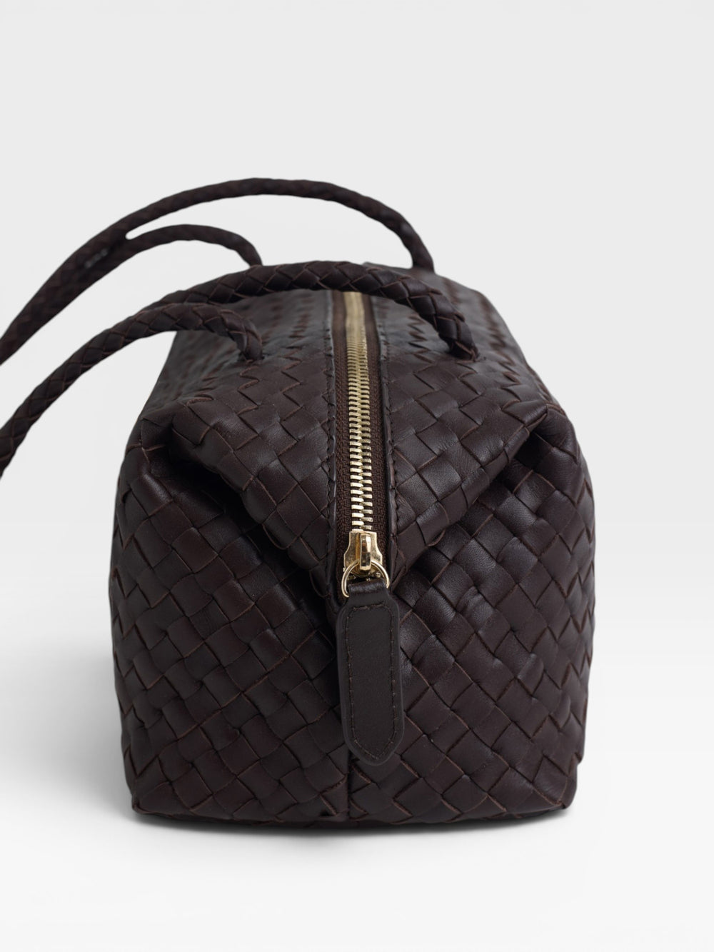 Elongated braided brown leather shoulder bag
