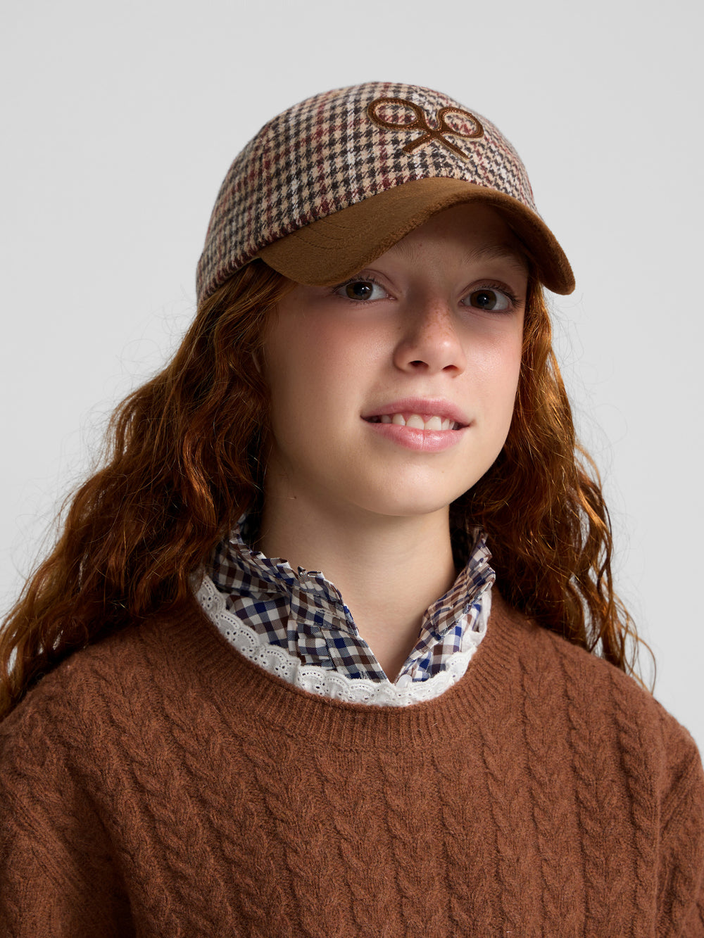 Brown cable knit girl's sweater with ruffled collar