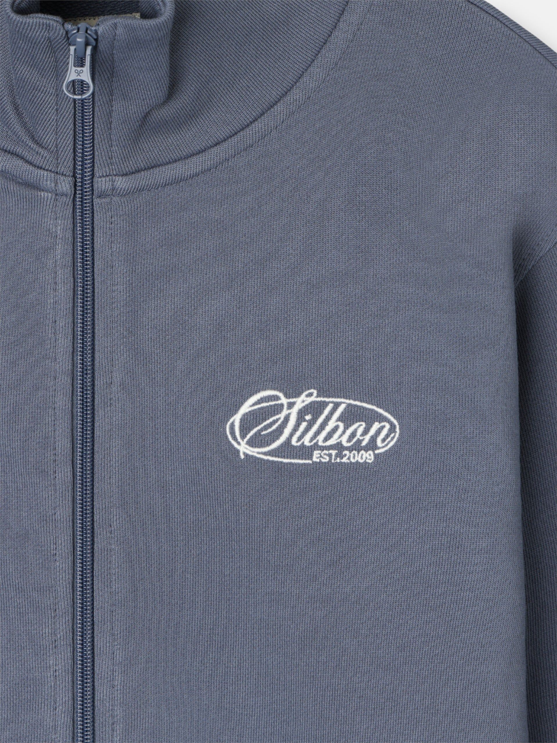 Sudadera cremallera bordado azul indigo
