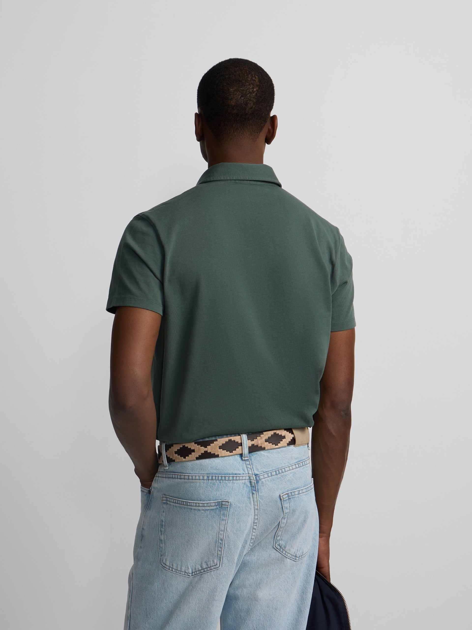 Short-sleeved polo with embossed green logo