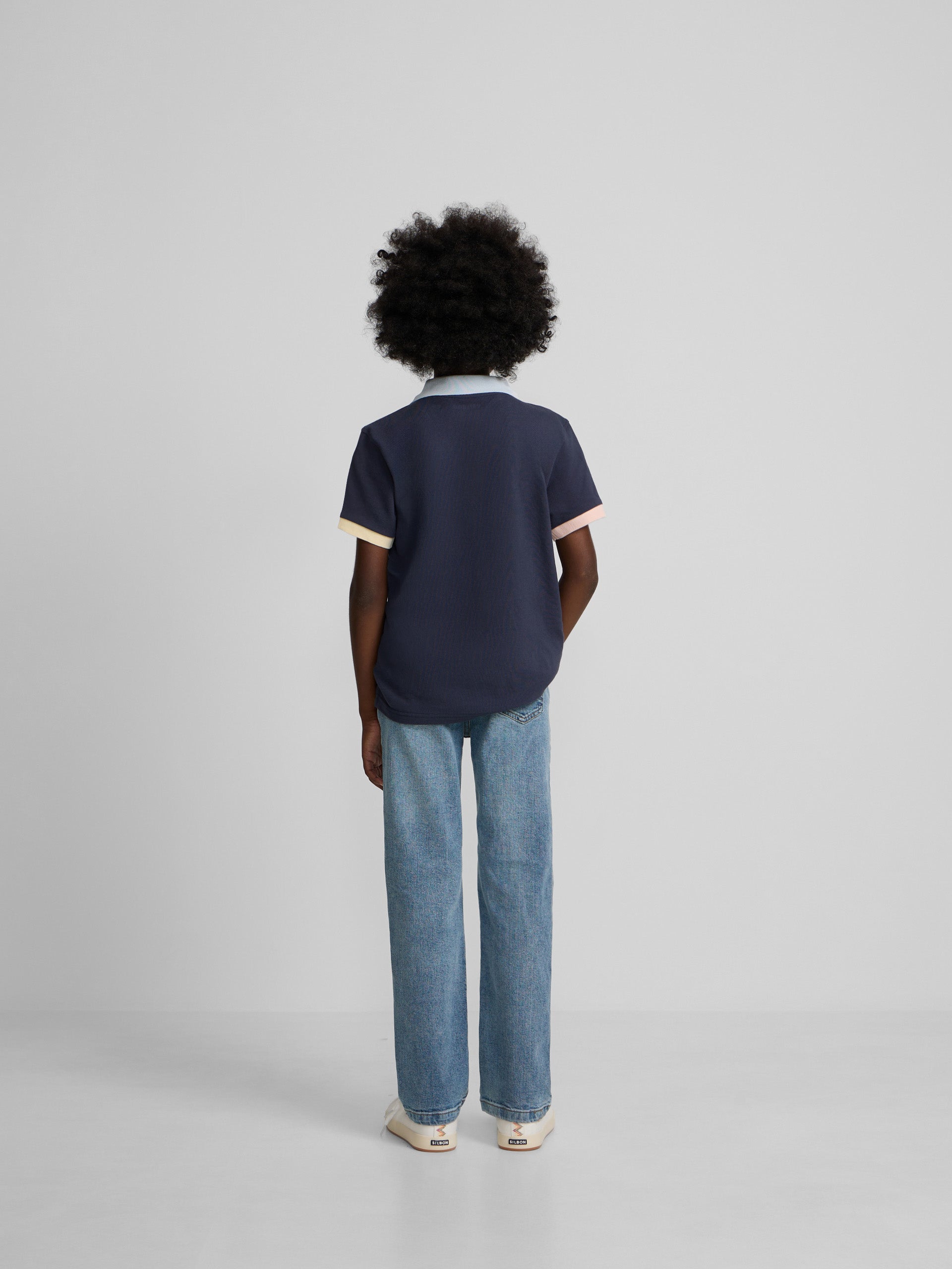 Navy blue kids polo with multicolor trim