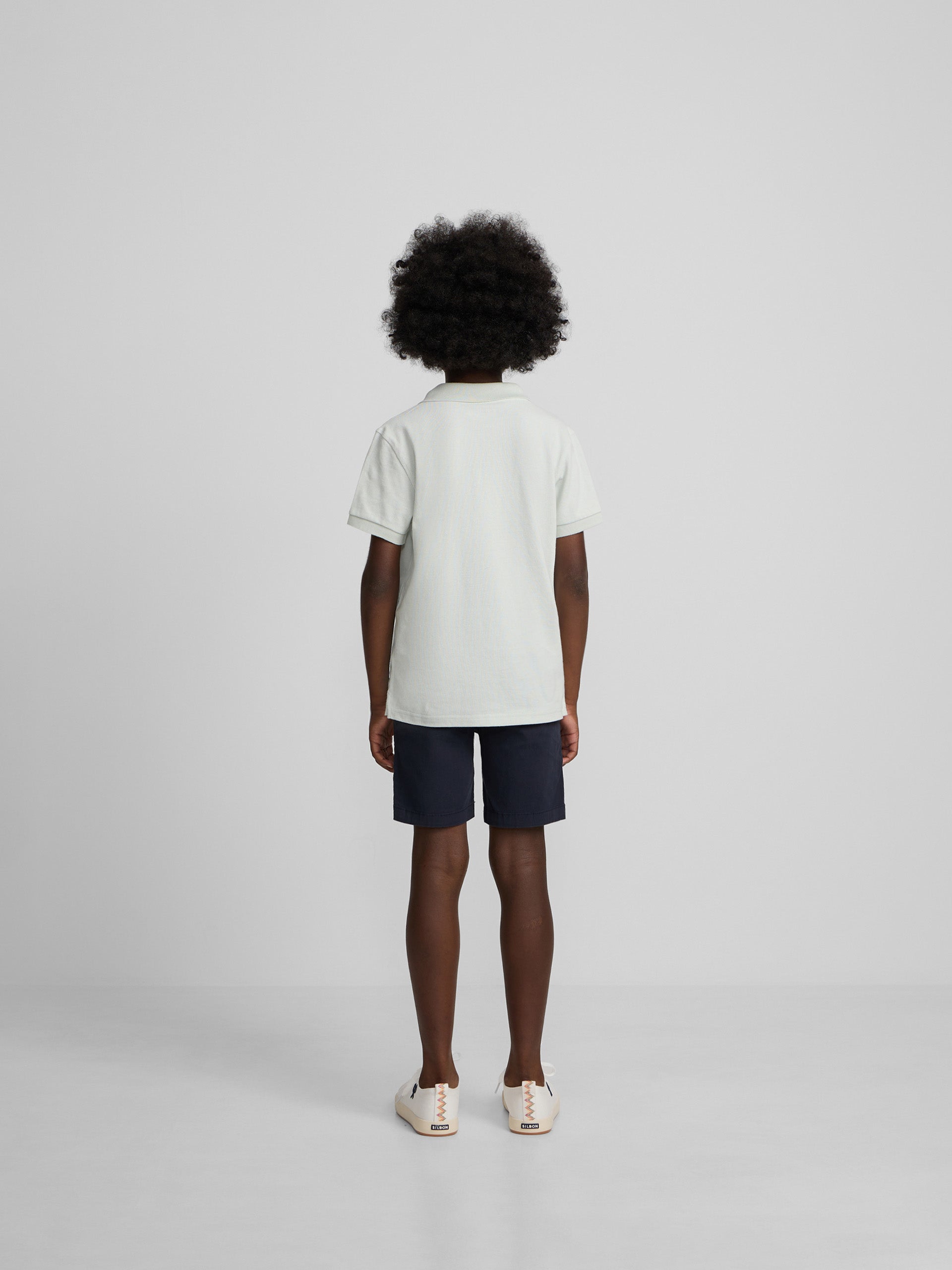 Polo enfant uni logo bouclé vert clair