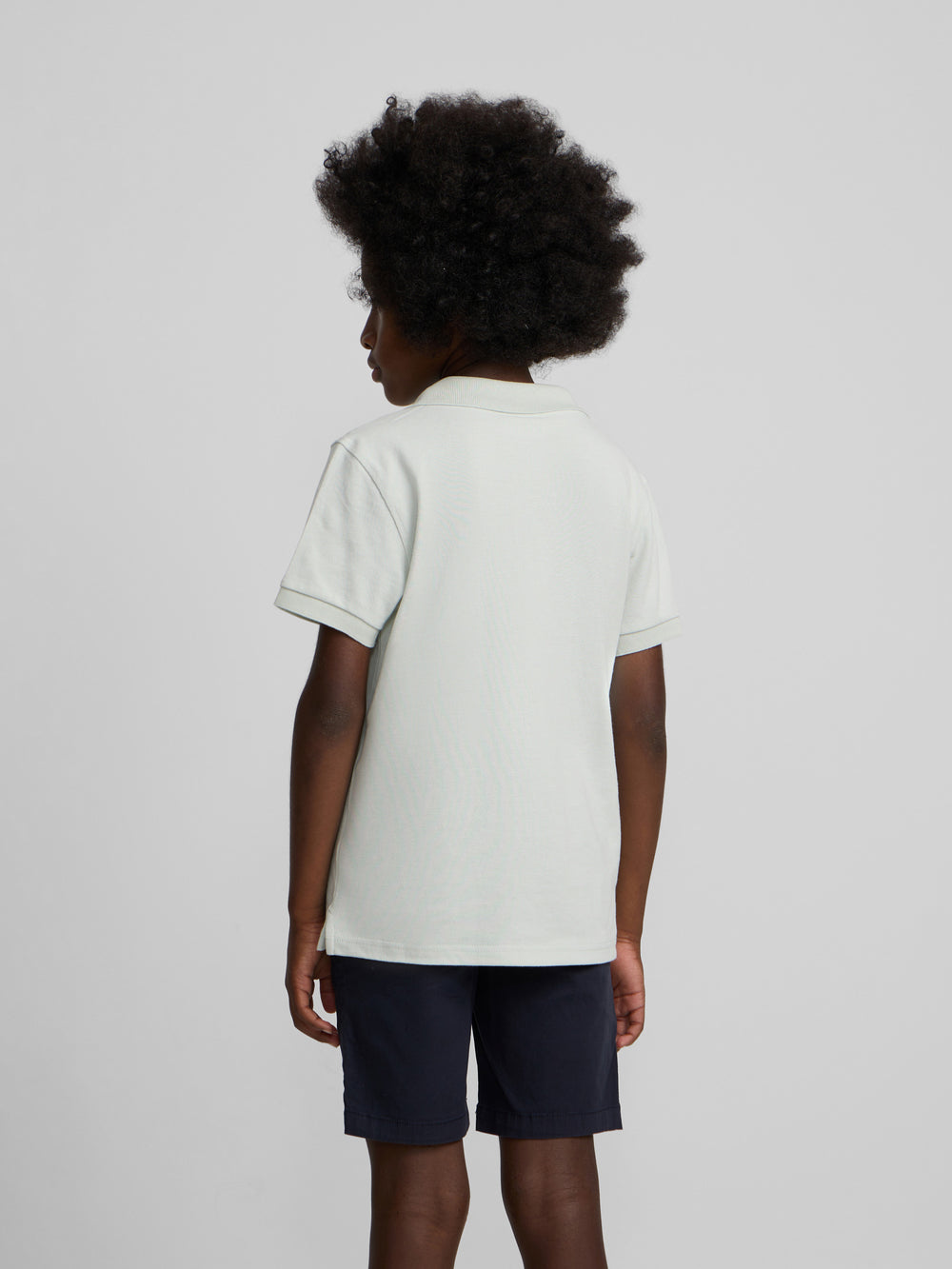 Polo enfant uni logo bouclé vert clair