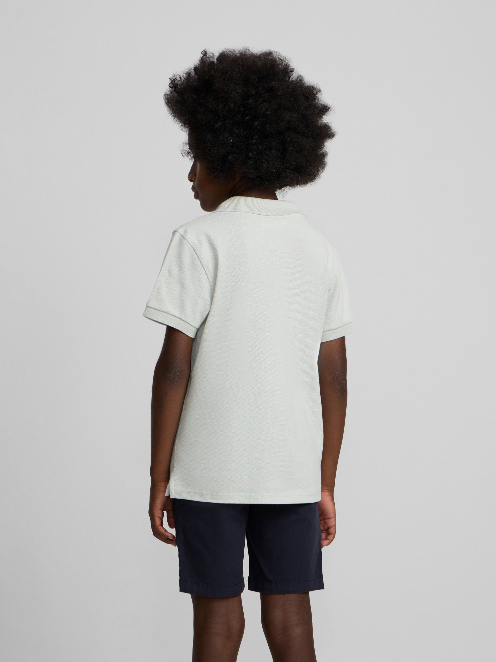 Polo enfant uni logo bouclé vert clair