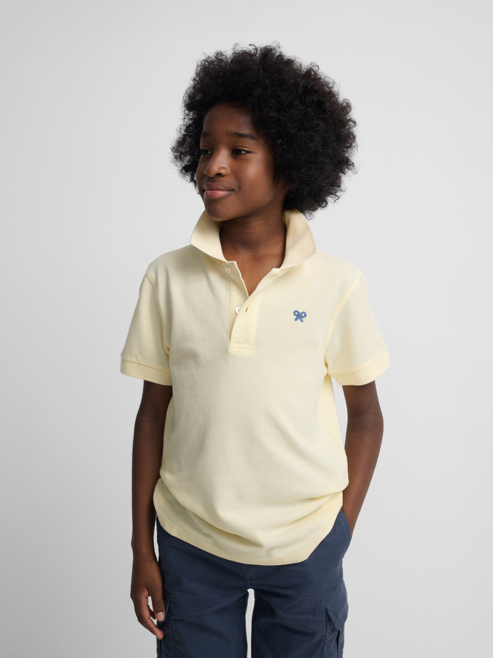 Polo enfant uni logo bouclé jaune