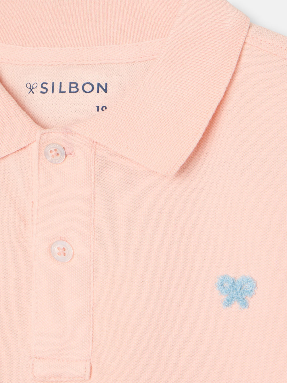 Polo enfant uni logo bouclé corail