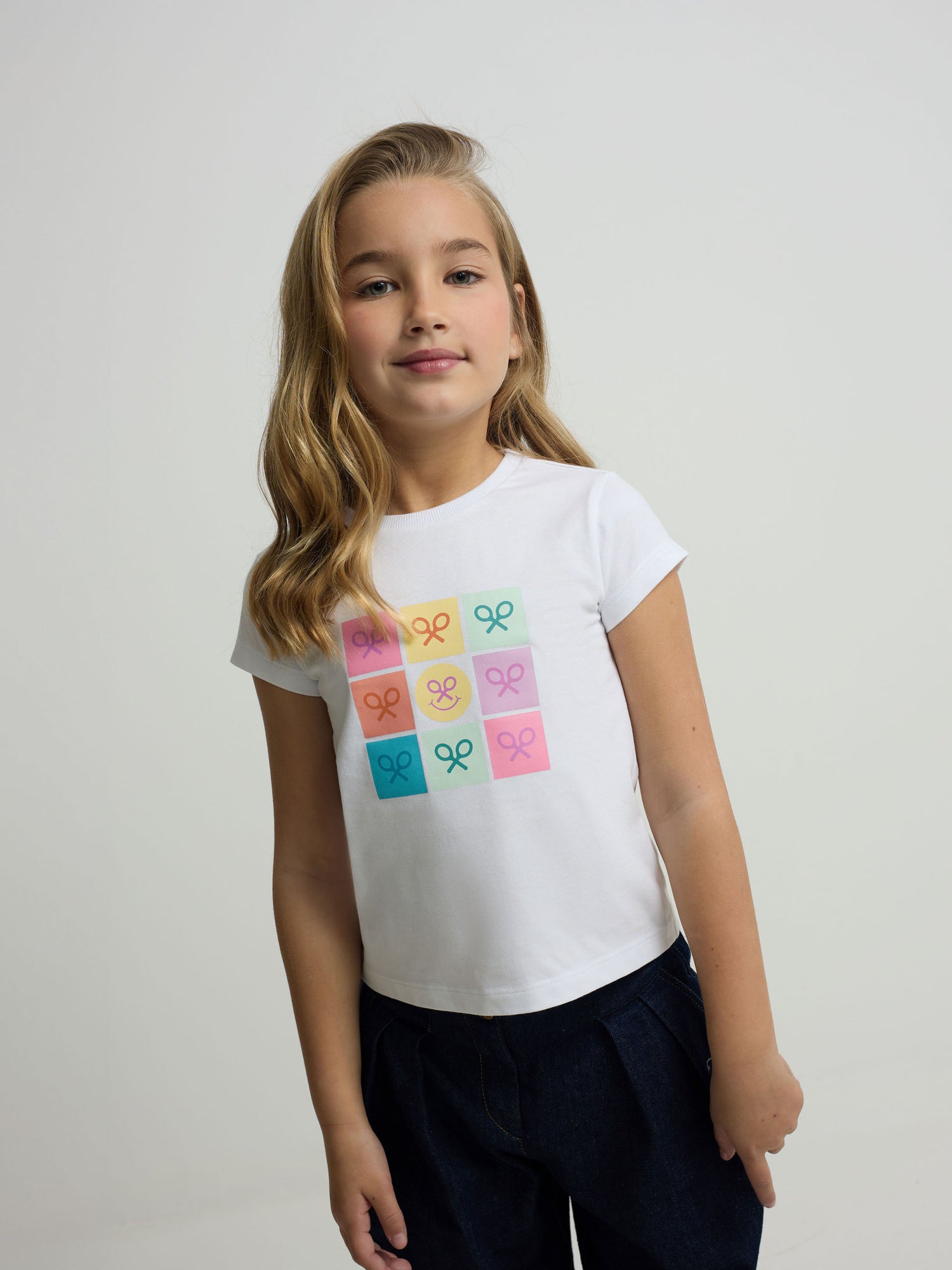 White girl's t-shirt with tennis rackets and smile