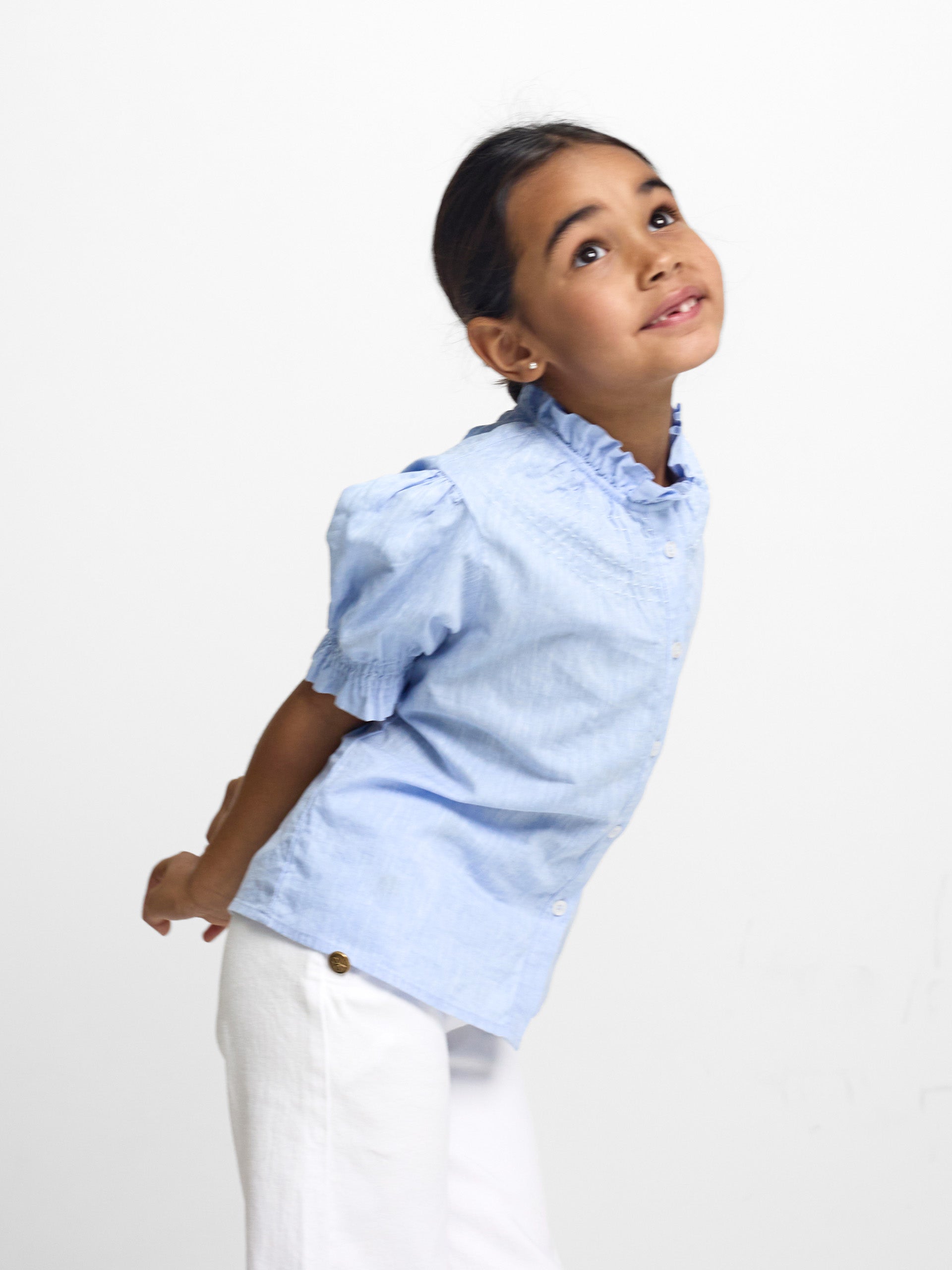 Girl's light blue linen shirt with ruffles